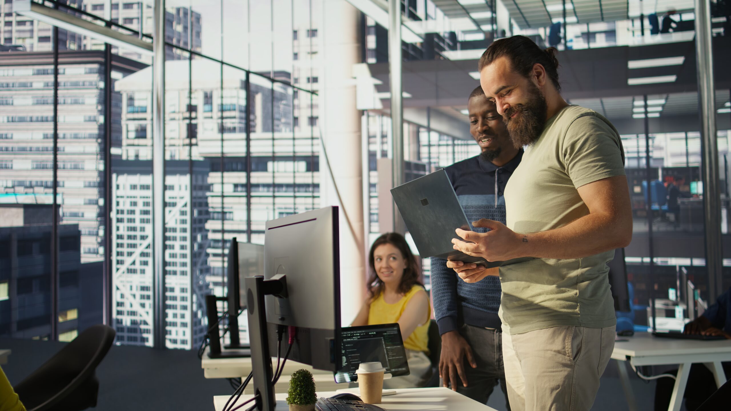 IT consulting team collaborating with laptop in office